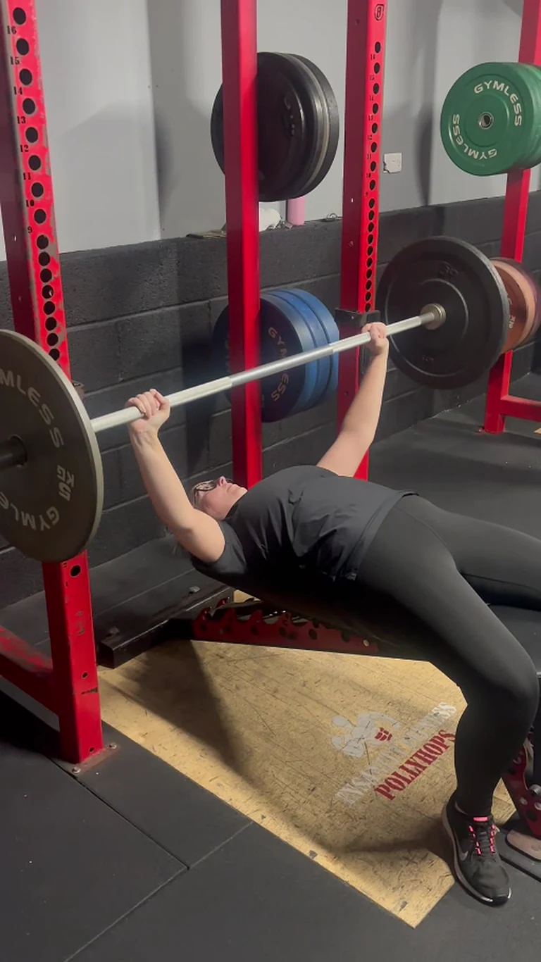 RITUAL member bench pressing during a coached strength session