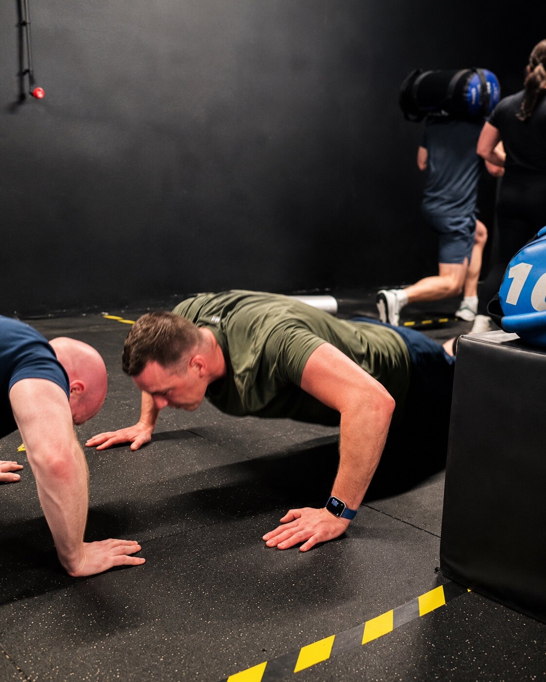 Adults completing push-ups during a Loc'Down training session